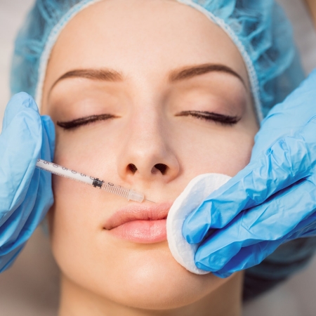Armonización Orofacial 6 Close-up of female patient receiving an injection on her face in clinic